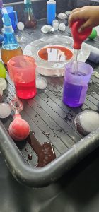 Child using droppers to paint ice